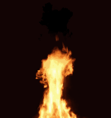 a large fire is going up in the dark