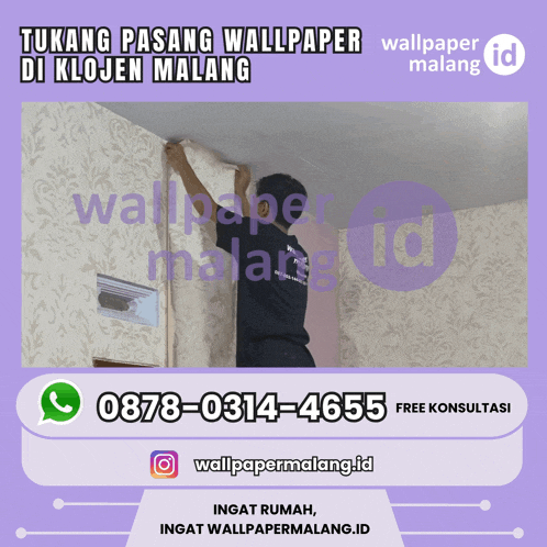 a man is hanging wallpaper on a wall with a phone number