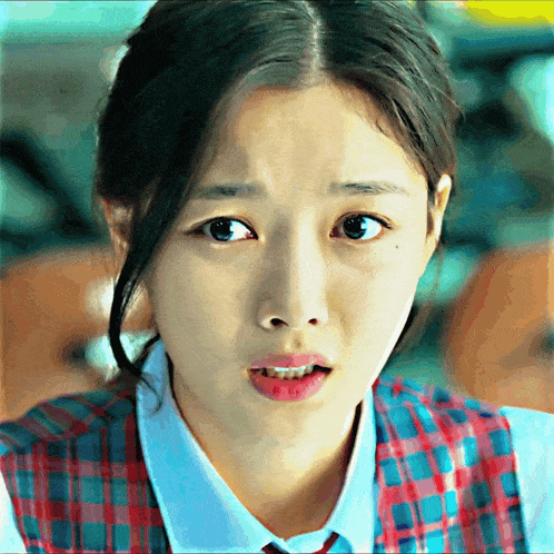 a close up of a girl making a funny face with her mouth open
