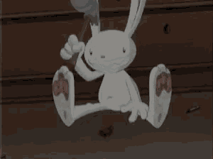 a cartoon rabbit is sitting on the floor with its feet up