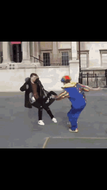 a man in a clown costume kicking another man in the face