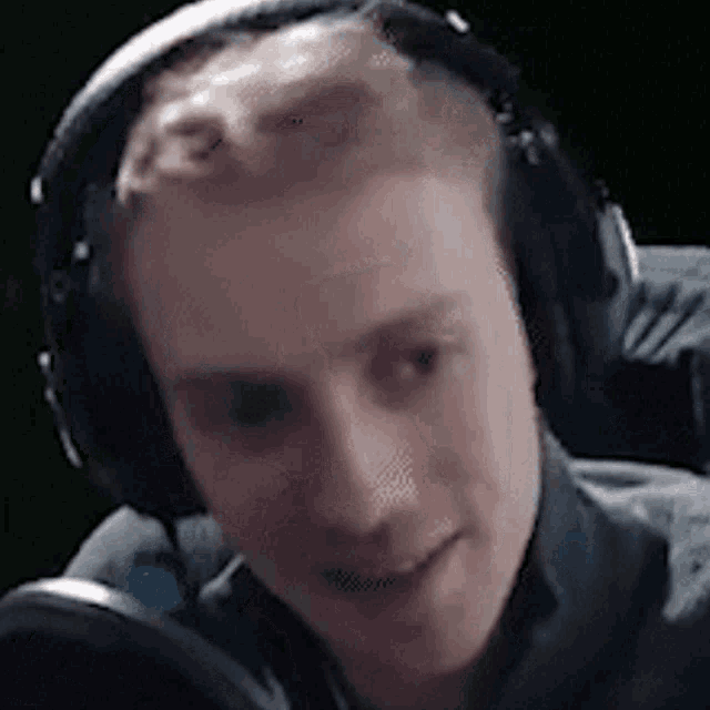 a close up of a man wearing headphones and a microphone