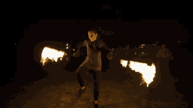 a man is holding a torch that is glowing brightly in the dark