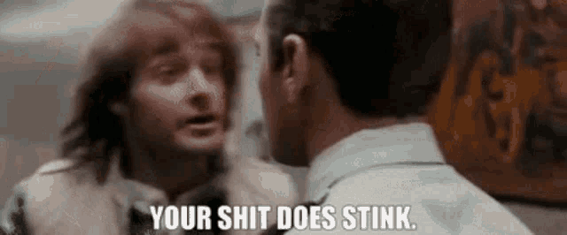 two men are talking to each other and one of them is saying your shit does stink .