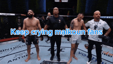 a group of men standing in a boxing ring with the words keep crying malkoun fans
