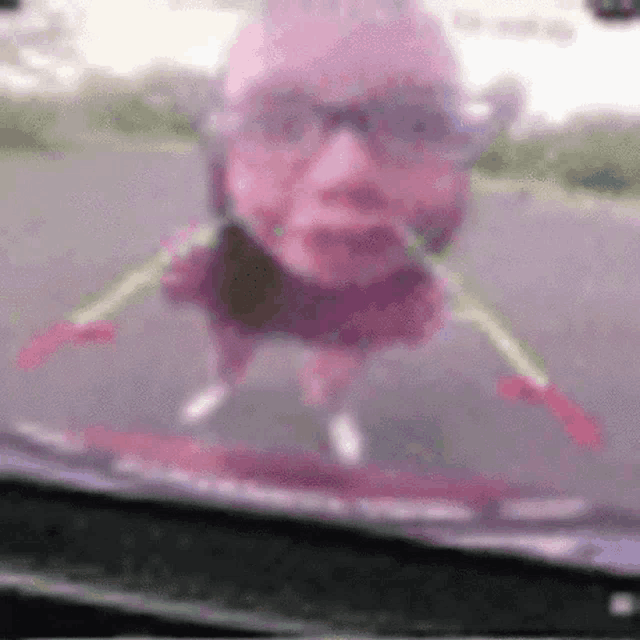 a blurry picture of a man 's face flying through a windshield .
