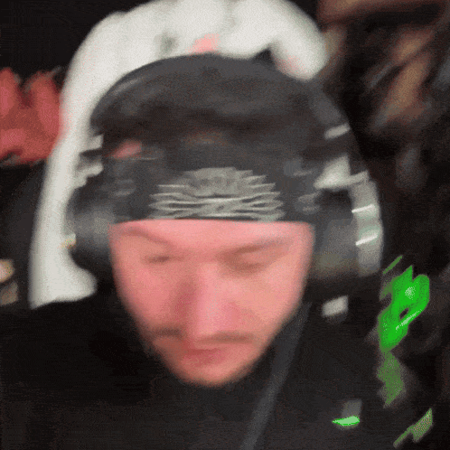 a blurry picture of a man wearing headphones and a headband