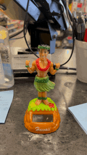 a figurine of a hula dancer from hawaii