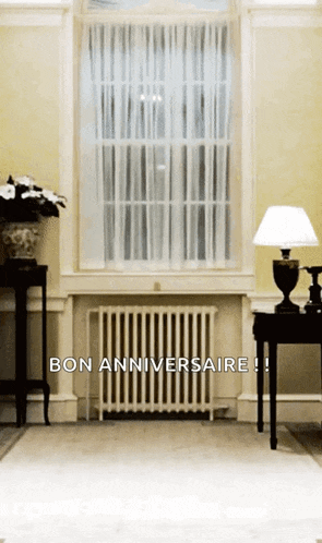 a room with a radiator and a lamp and the words bon anniversaire on the bottom