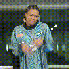 a man wearing a blue nike shirt is dancing in a room .