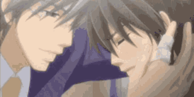 two anime characters are hugging each other in a blurry picture .