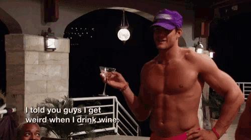 a shirtless man holds a martini glass and says i told you guys