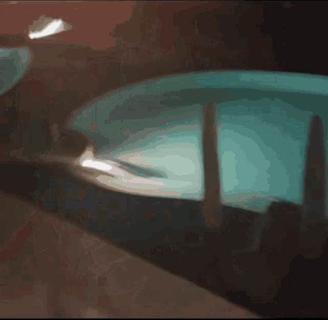a blurred image of a swimming pool at night with a light shining on it