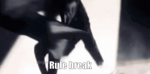 a close up of a person holding a gun with the words `` rule break '' written on the bottom .