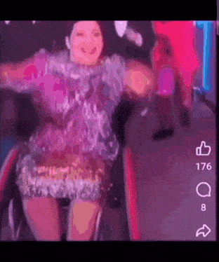 a woman in a wheelchair with a purple dress is dancing