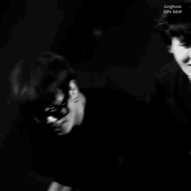 a black and white photo of jungkook with the words jungkook gif 's b & w on the bottom