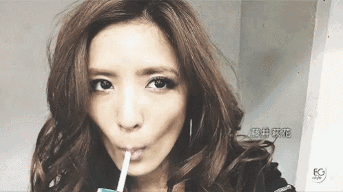 a close up of a woman drinking through a straw with eg style written on the bottom