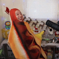 a woman in a hot dog costume is standing in front of a window .