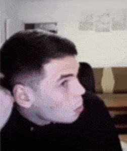 a close up of a man 's face in a living room with a blurred background .