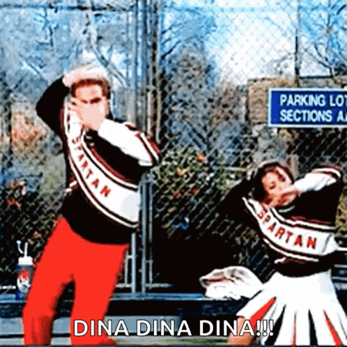 two spartan cheerleaders are dancing in front of a parking lot sections sign