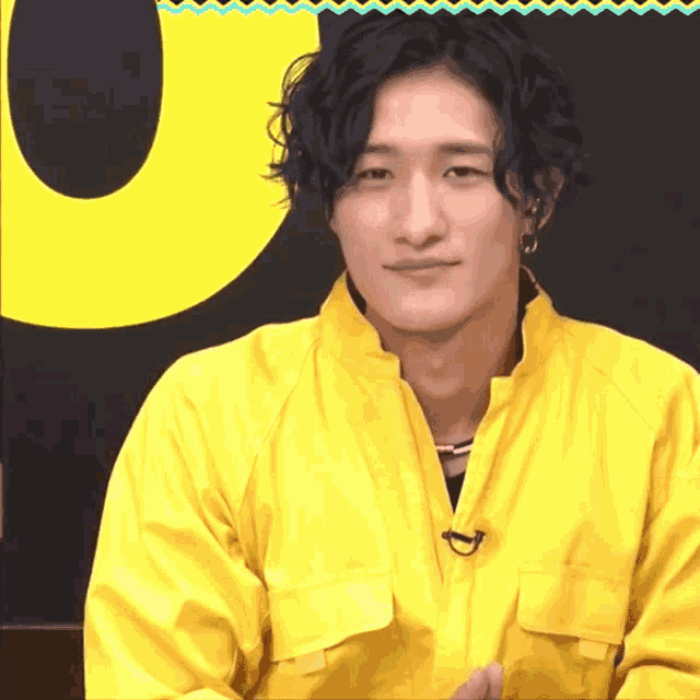 a man wearing a yellow jacket with a microphone on it