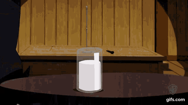 a cartoon shows a glass container with a white substance inside of it and says gifs.com on the bottom