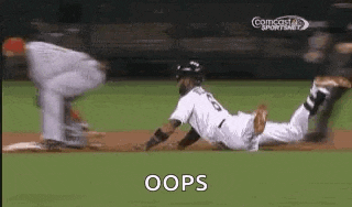 a baseball player is sliding into base while a catcher tries to catch the ball .