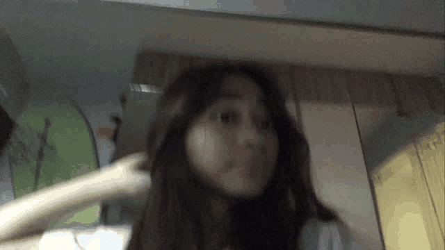 a blurry picture of a woman 's face in a room