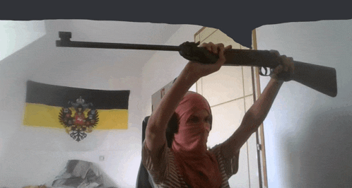 a person holding a rifle over their head in front of a flag that says ' russia ' on it