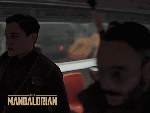 a poster for the mandalorian shows a man in a suit
