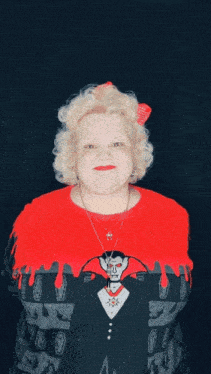 a woman wearing a vampire sweater with blood dripping from it