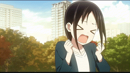 a girl with black hair is holding a piece of paper in front of her face and making a funny face .