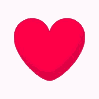 a red heart is sitting on a white surface .