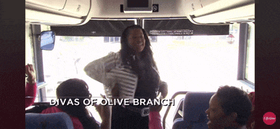 a woman on a bus with the words divas of olive branch