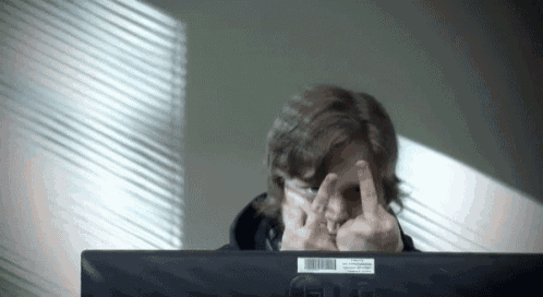 a man giving the middle finger in front of an lg computer