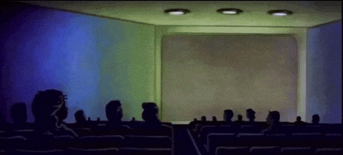 a group of people watching a movie in a theater