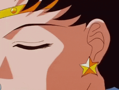 a close up of a person 's ear with a star shaped earring .
