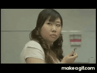 a woman is holding a cell phone in her hand .