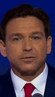 a man in a suit and tie is giving a speech .