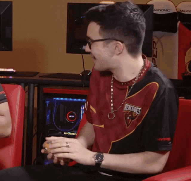 a man wearing a red and black shirt that says phoenixes