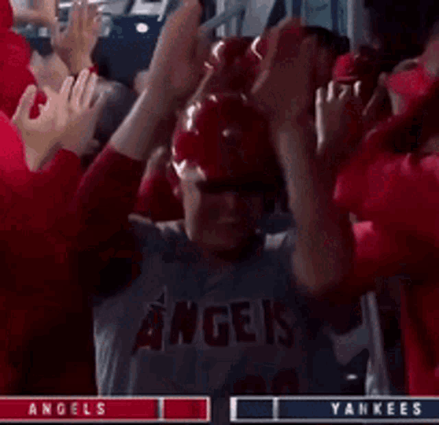 a baseball player with the number 20 on his shirt is surrounded by fans