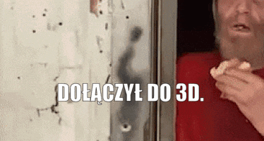 a man with a beard is eating a sandwich in front of a wall with bullet holes in it .