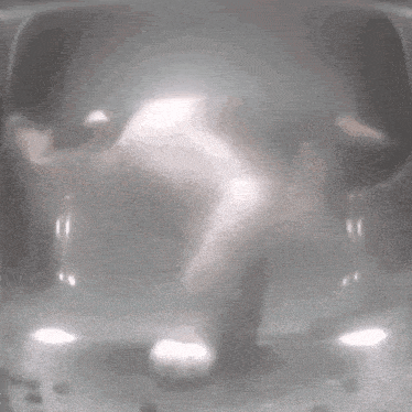 a blurred image of a person 's face with a light coming out of it