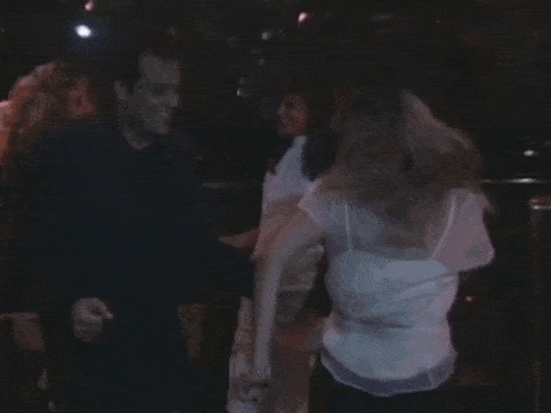 a man and a woman are dancing in a club