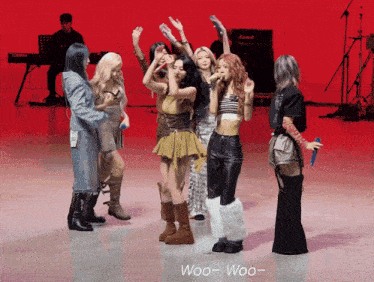a group of women dancing on a stage with the words woo-woo- on the bottom right