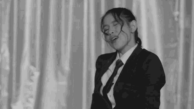 a black and white photo of a woman in a suit