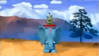 a blue elephant with a frog on its head is standing in a desert .