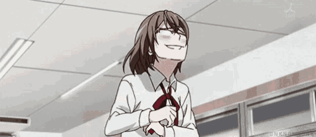 a girl in a school uniform is making a funny face while standing in a classroom .