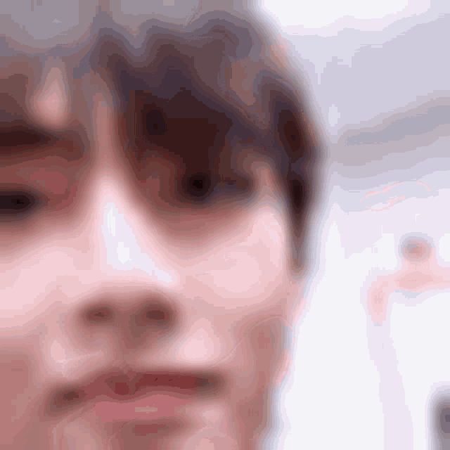 a close up of a person 's face with a blurry background