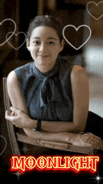 a woman sits in a chair with hearts around her and the words moonlight behind her